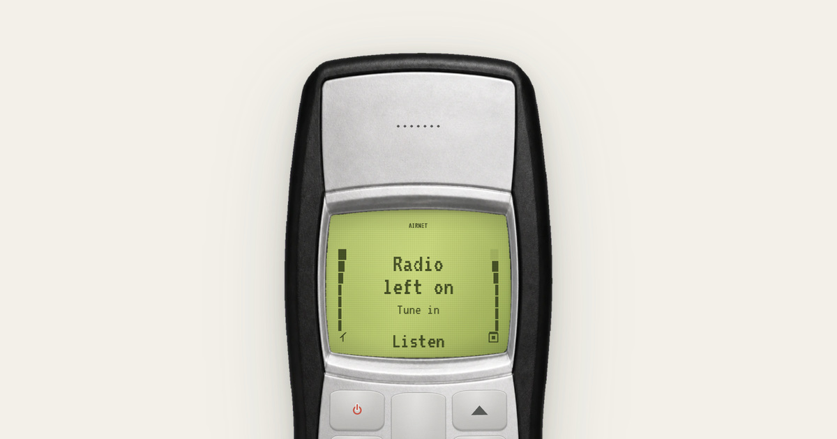 Classic keypad phone with a green screen showing radio left on — Full Talktime
